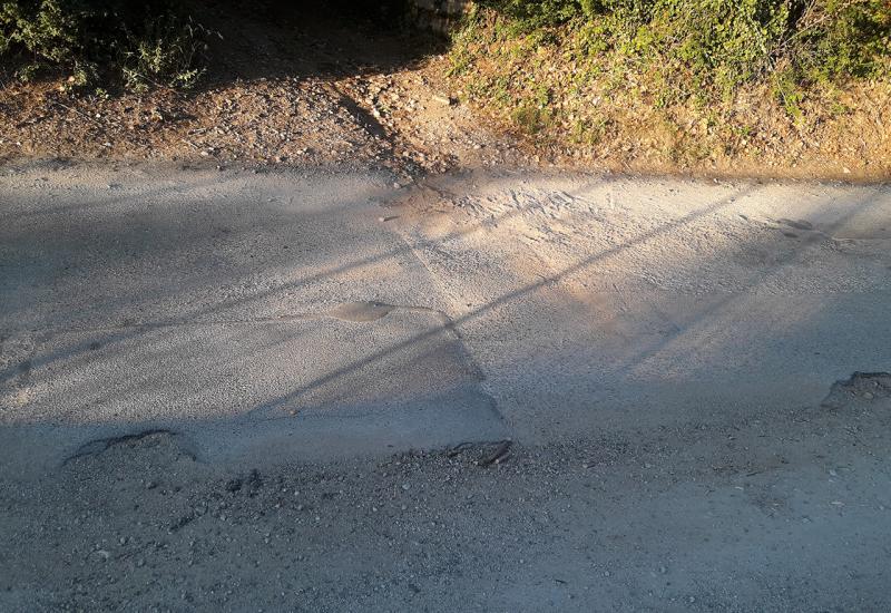 Rupama razrovana i prašnjava cesta u naselju - Cesta Buna-Blagaj: Cesta kroz naselje prepuna rupa, prašnjava i zapuštena