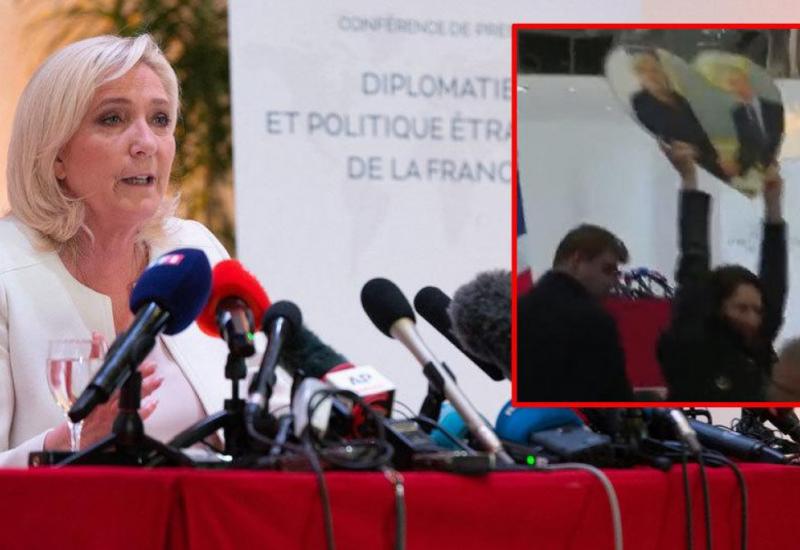 VIDEO: Prekinuta press konferencija Le Pen, djevojka podigla Putinovu sliku