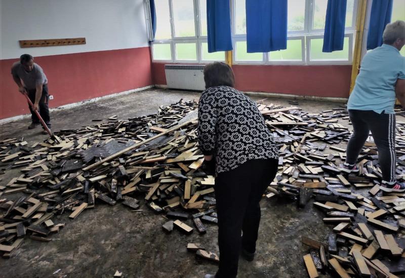 Uposlenici škole u Teočaku rade na uklanjanju oštećenih dijelova poda - U Teočaku strahuju od pojave klizišta, milijunske štete na cestama
